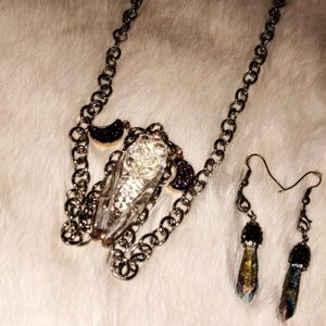 A insect necklace with the earrings